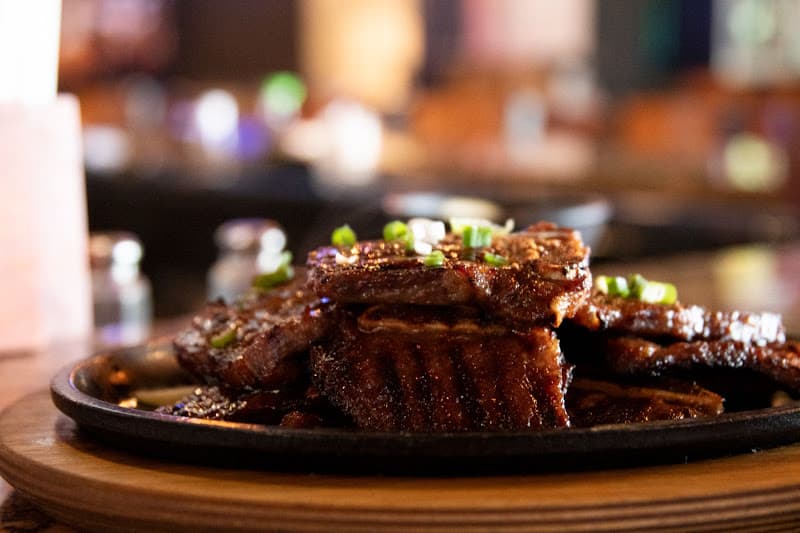 Marinated beef caramelizing on the tabletop grill at Matjoa House